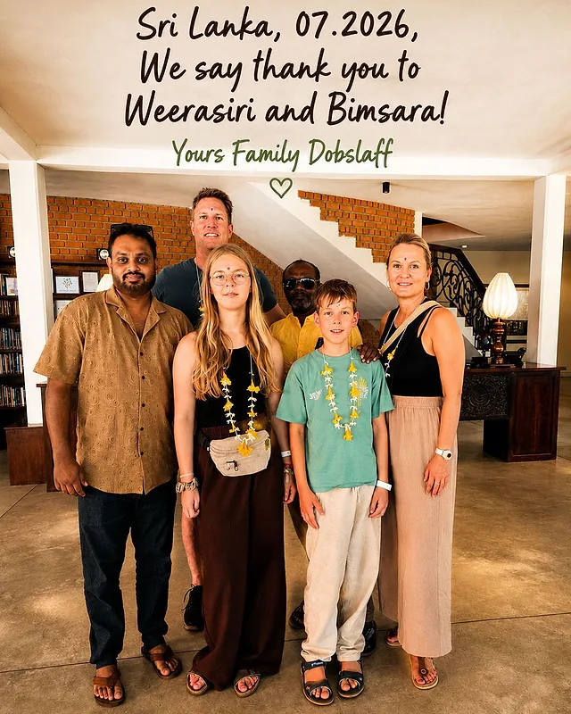 A family wearing flower garlands with their guides in a hotel lobby, under a handwritten thank-you note
