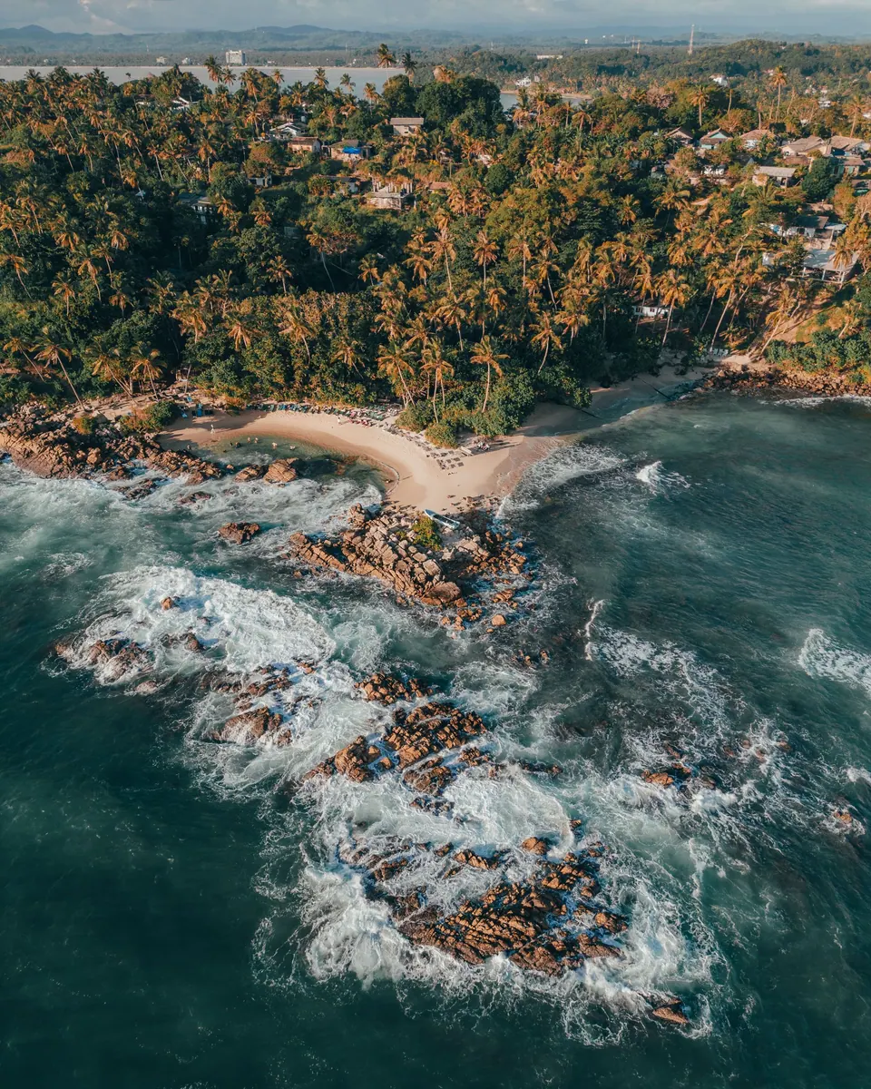 Aerial view of Mirissa bay and its green headland