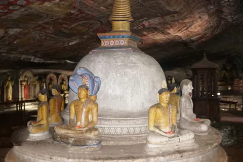 Buddha statues and a stupa inside the Dambulla cave temple