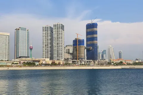 The Colombo skyline rising behind the Indian Ocean waterfront