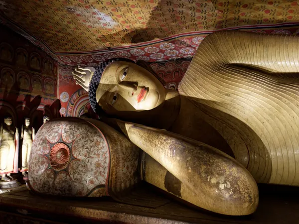 The reclining Buddha beneath painted ceilings in Dambulla's caves