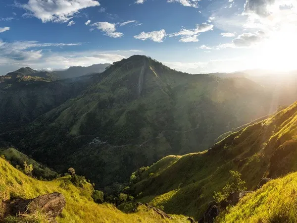 Sunrise over a green valley in Sri Lanka’s hill country
