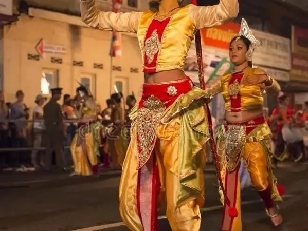 A Kandyan dancer in traditional costume performing on the street