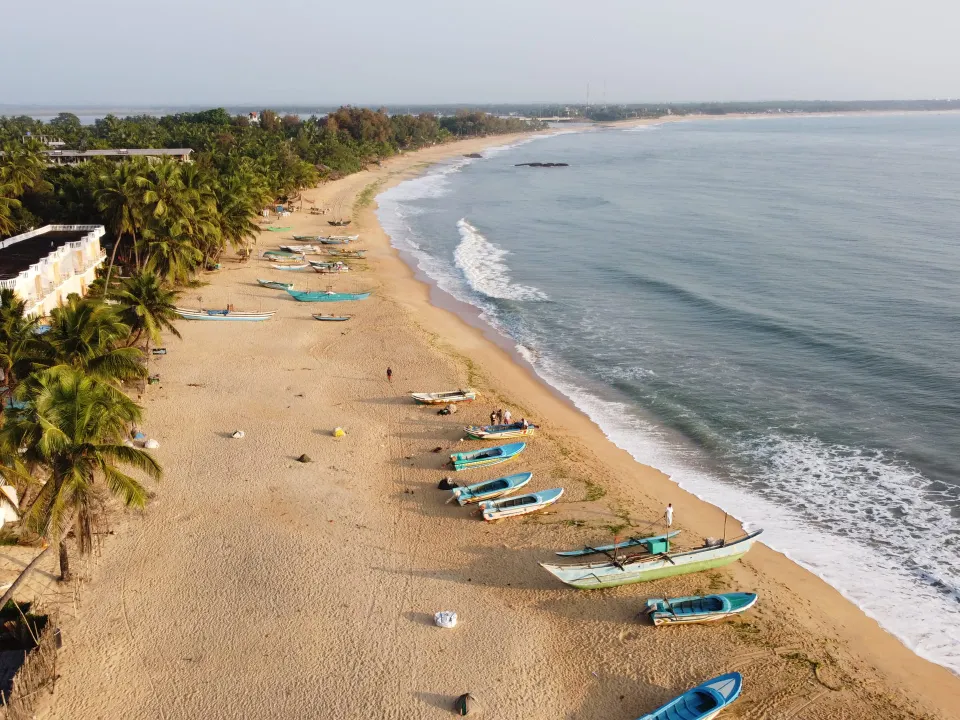 Fishing boats on the curve of Arugam Bay from above