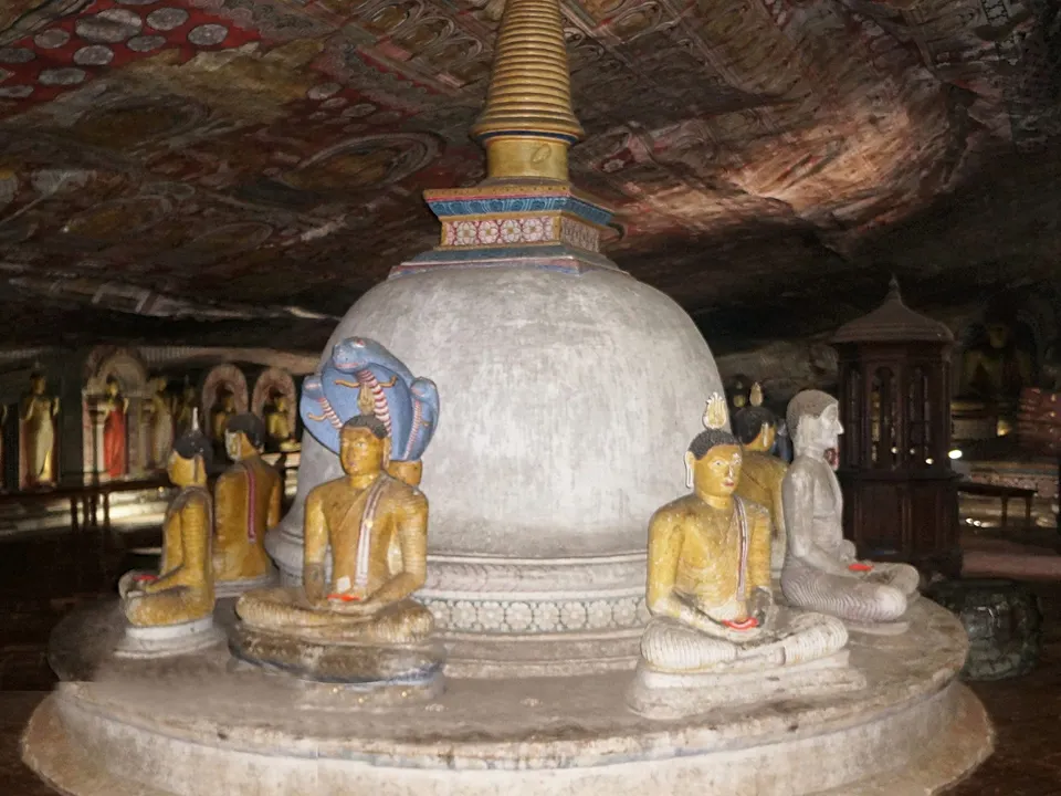 Buddha statues and a stupa inside the Dambulla cave temple