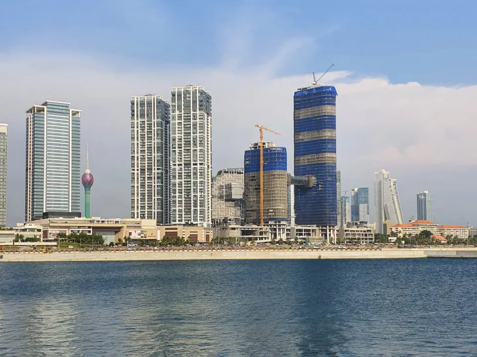 The Colombo skyline rising behind the Indian Ocean waterfront